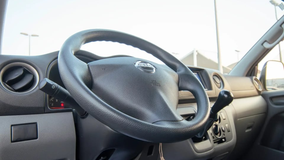 Used 2022 Nissan Urvan Standard Roof in White – Driver Side Dashboard & Steering View for Sale at First Choice Cars Dubai Sharjah