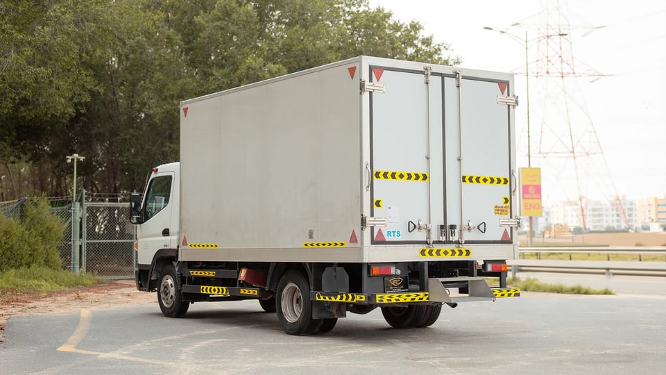 Used 2023 Mitsubishi Canter Chiller Box in White – Left Back Diagonal (45°) View for Sale at First Choice Cars Dubai Sharjah