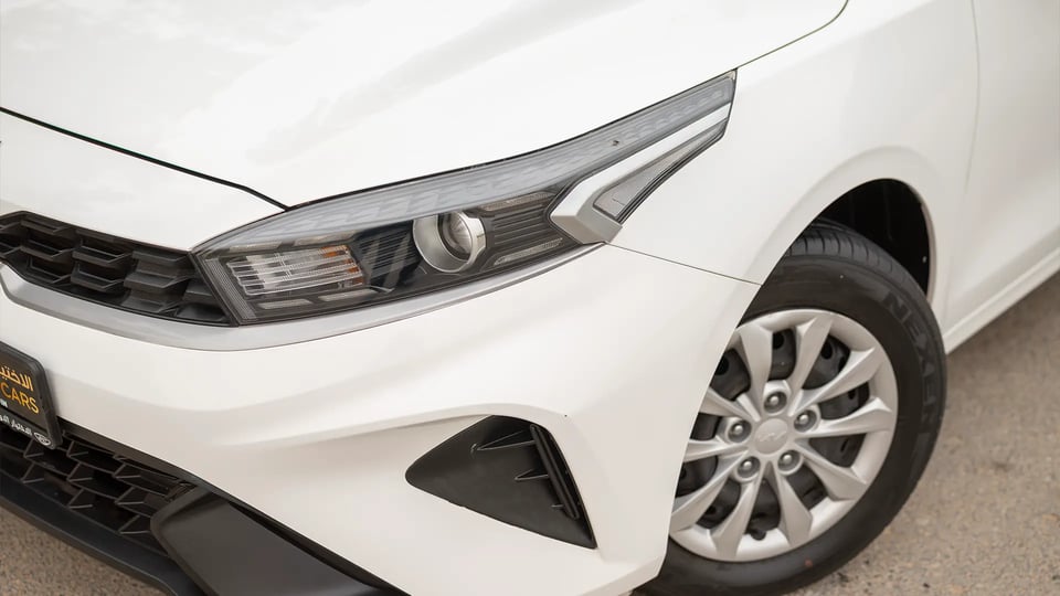 Used 2023 Kia Cerato LX in White – Headlight Close-up for Sale at First Choice Cars Dubai Sharjah