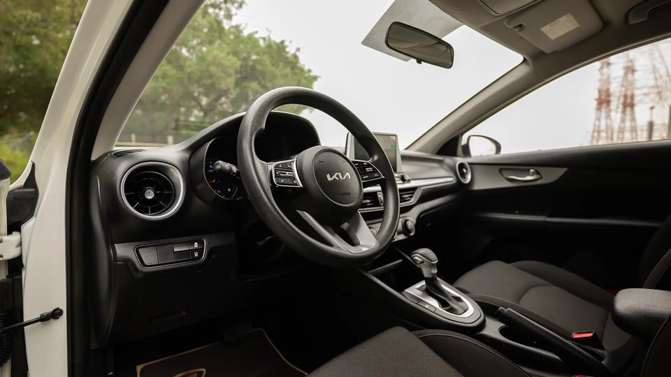 Used 2023 Kia Cerato LX in White – Driver Side Dashboard & Steering View for Sale at First Choice Cars Dubai Sharjah