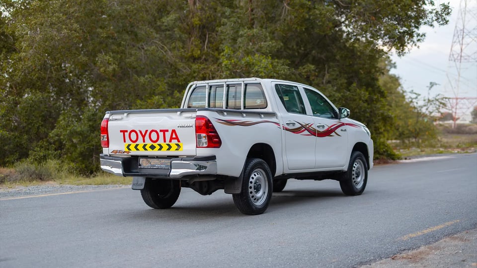 Used 2021 Toyota Hilux DLX Double Cabin in White – Right Back Diagonal (45°) View for Sale at First Choice Cars Dubai Sharjah