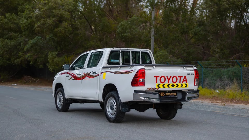 Used 2021 Toyota Hilux DLX Double Cabin in White – Left Back Diagonal (45°) View for Sale at First Choice Cars Dubai Sharjah
