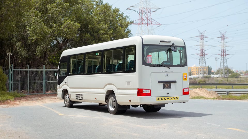 Used 2022 Toyota Coaster High Roof in White – Left Back Diagonal (45°) View for Sale at First Choice Cars Dubai Sharjah