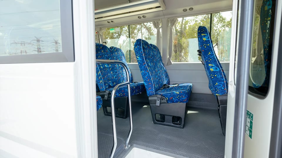 Used 2022 Toyota Coaster High Roof in White – Rear Passenger Side Cabin View for Sale at First Choice Cars Dubai Sharjah