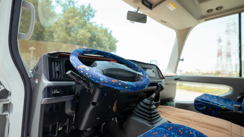 Used 2022 Toyota Coaster High Roof in White – Driver Side Dashboard & Steering View for Sale at First Choice Cars Dubai Sharjah