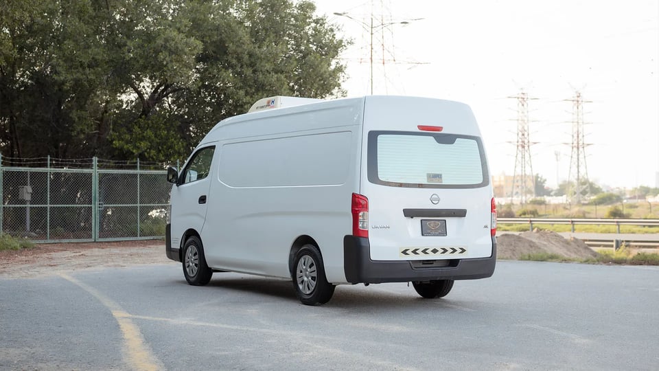 Used 2023 Nissan Urvan High Roof in White – Left Back Diagonal (45°) View for Sale at First Choice Cars Dubai Sharjah