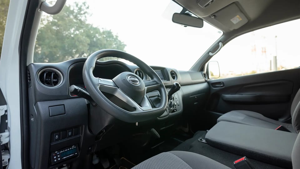 Used 2023 Nissan Urvan High Roof in White – Driver Side Dashboard & Steering View for Sale at First Choice Cars Dubai Sharjah