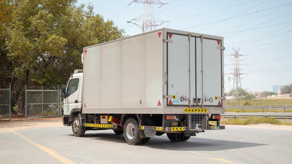 Used 2020 Mitsubishi Canter Chiller Box in White – Left Back Diagonal (45°) View for Sale at First Choice Cars Dubai Sharjah