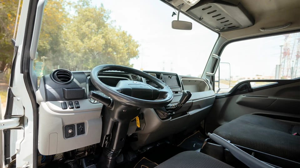 Used 2020 Mitsubishi Canter Chiller Box in White – Driver Side Dashboard & Steering View for Sale at First Choice Cars Dubai Sharjah