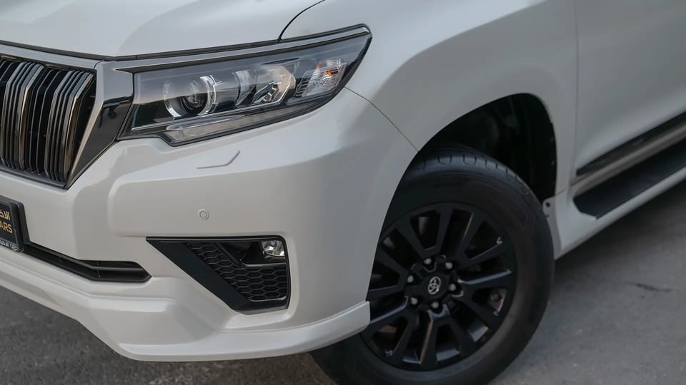 Used 2022 Toyota Prado VXR in White – Headlight Close-up for Sale at First Choice Cars Dubai Sharjah