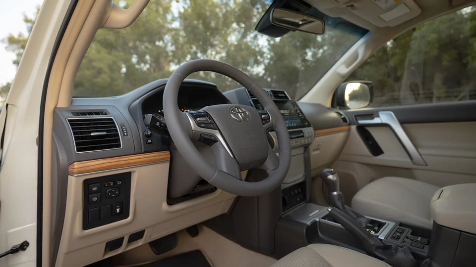 Used 2022 Toyota Prado VXR in White – Driver Side Dashboard & Steering View for Sale at First Choice Cars Dubai Sharjah