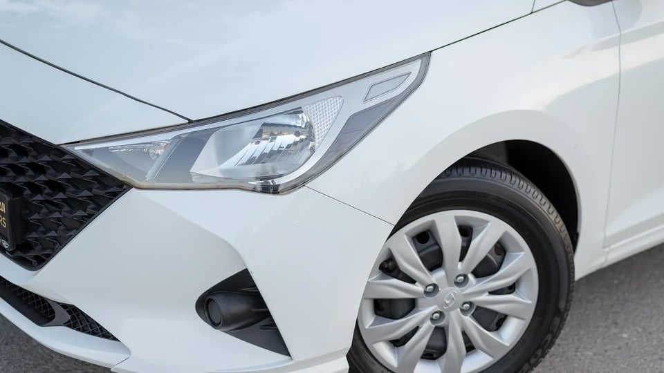 Used 2023 Hyundai Accent Smart in White – Headlight Close-up for Sale at First Choice Cars Dubai Sharjah