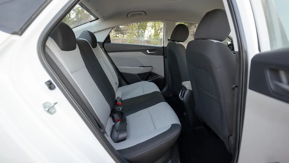 Used 2023 Hyundai Accent Smart in White – Rear Passenger Side Cabin View for Sale at First Choice Cars Dubai Sharjah