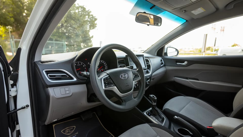 Used 2023 Hyundai Accent Smart in White – Driver Side Dashboard & Steering View for Sale at First Choice Cars Dubai Sharjah