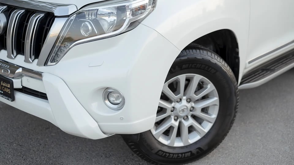 Used 2016 Toyota Prado VXR in White – Headlight Close-up for Sale at First Choice Cars Dubai Sharjah