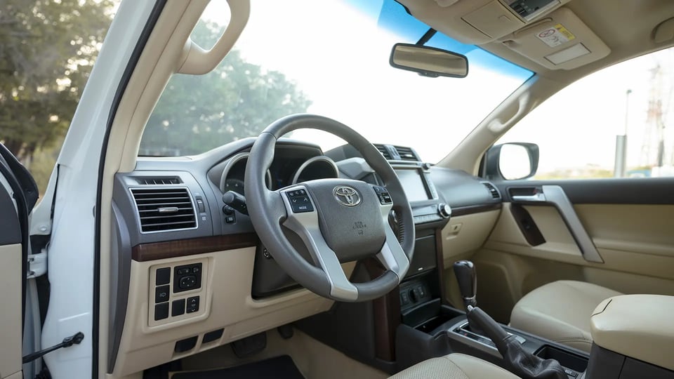 Used 2016 Toyota Prado VXR in White – Driver Side Dashboard & Steering View for Sale at First Choice Cars Dubai Sharjah