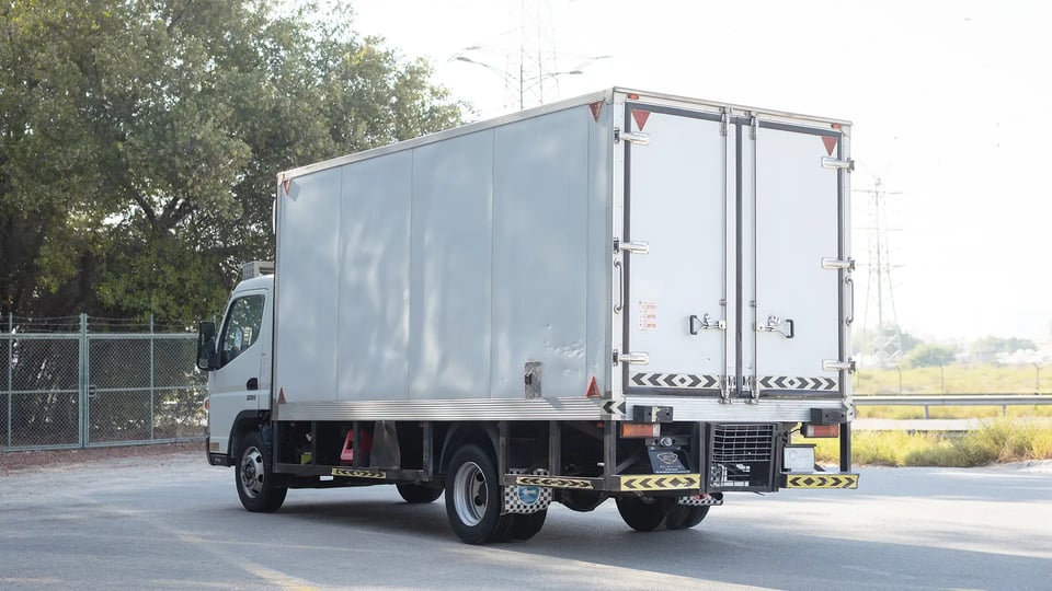 Used 2022 Mitsubishi Canter Chiller Box in White – Left Back Diagonal (45°) View for Sale at First Choice Cars Dubai Sharjah