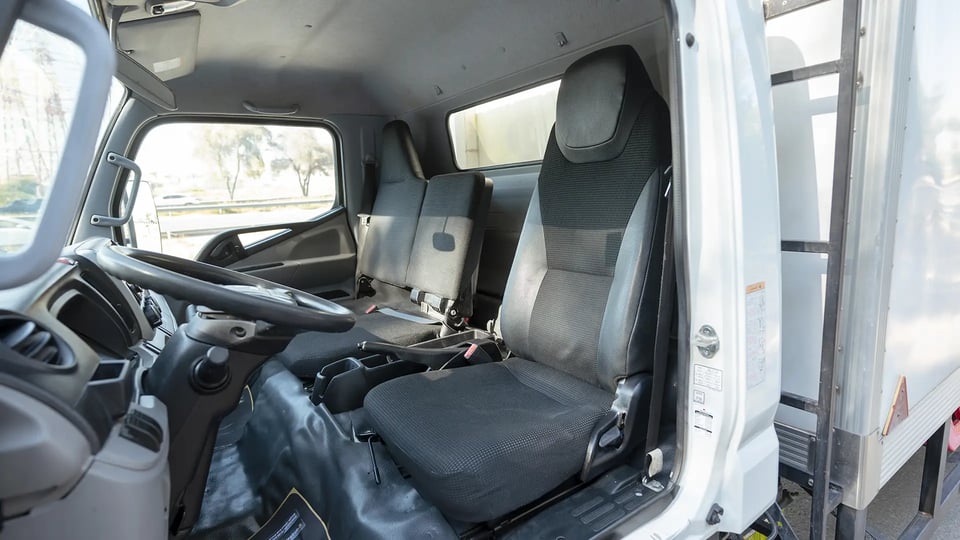 Used 2022 Mitsubishi Canter Chiller Box in White – Front Driver Side Cabin View for Sale at First Choice Cars Dubai Sharjah