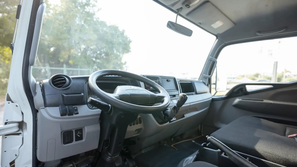 Used 2022 Mitsubishi Canter Chiller Box in White – Driver Side Dashboard & Steering View for Sale at First Choice Cars Dubai Sharjah