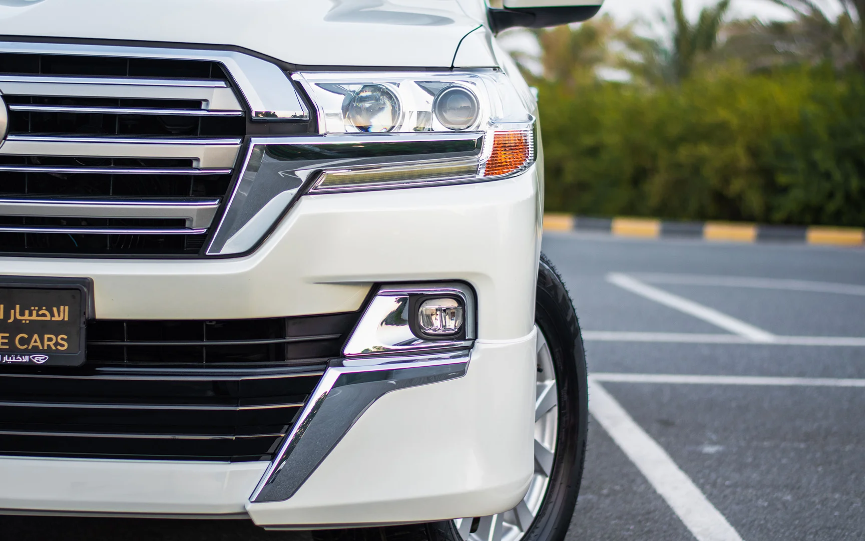 Used 2021 Toyota Land Cruiser GXR White – Headlight Close-up at First Choice Cars Sharjah