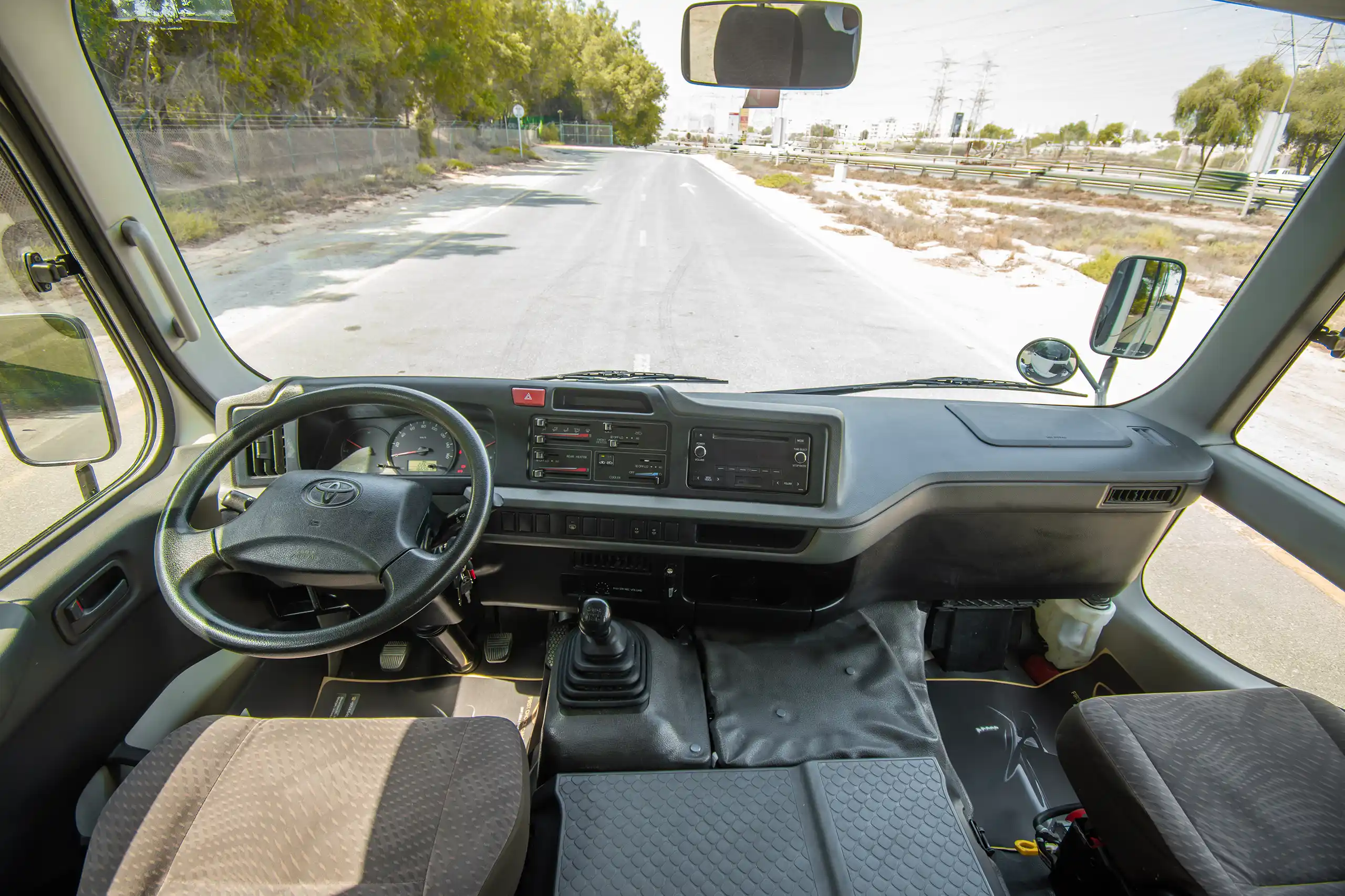 Used 2020 Toyota Coaster Bus White – Front Cabin / Dashboard Full View at First Choice Cars Sharjah