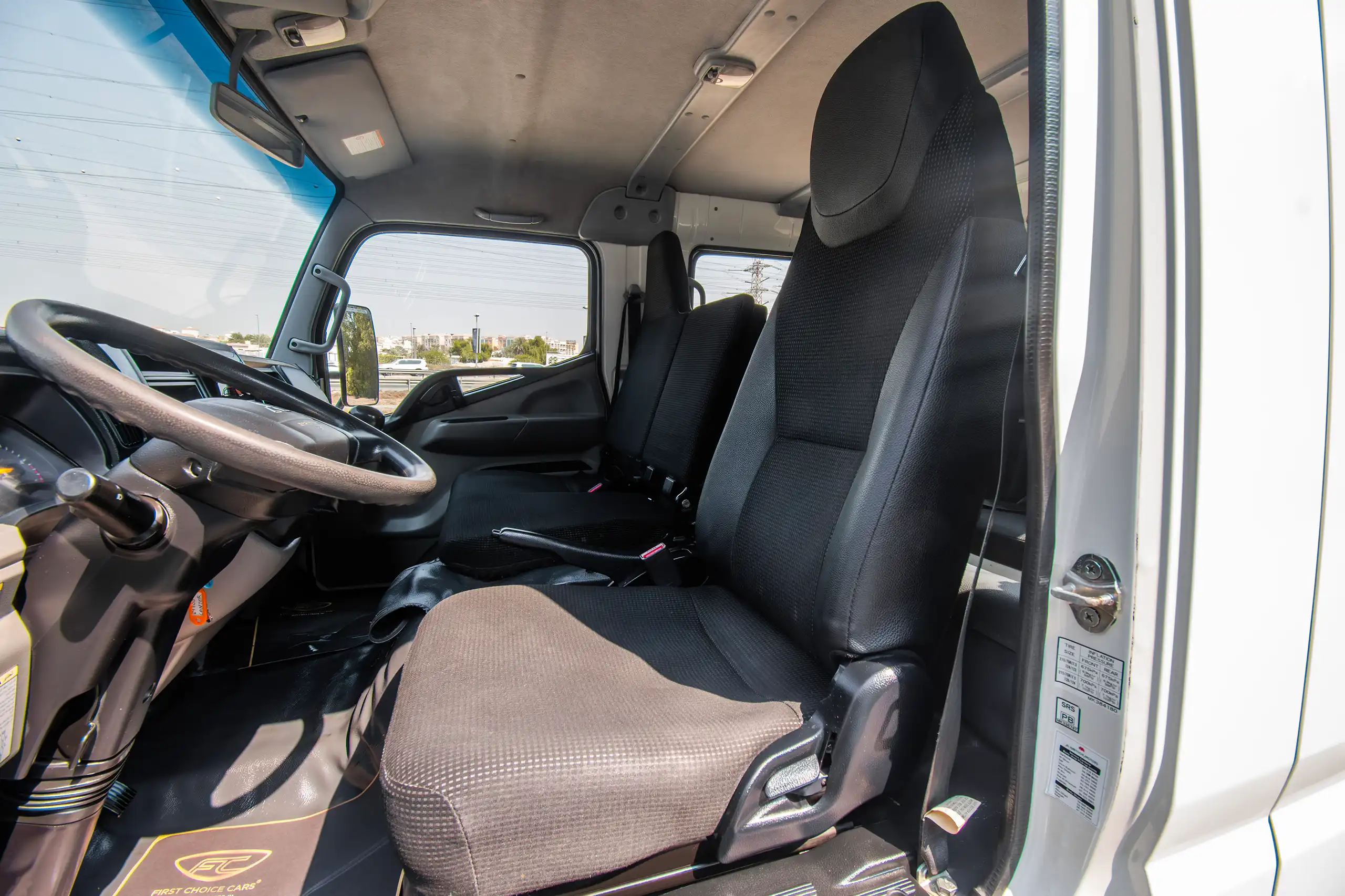 Used 2023 Mitsubishi Canter Double Cabin White – Front Driver Side Cabin View at First Choice Cars Sharjah