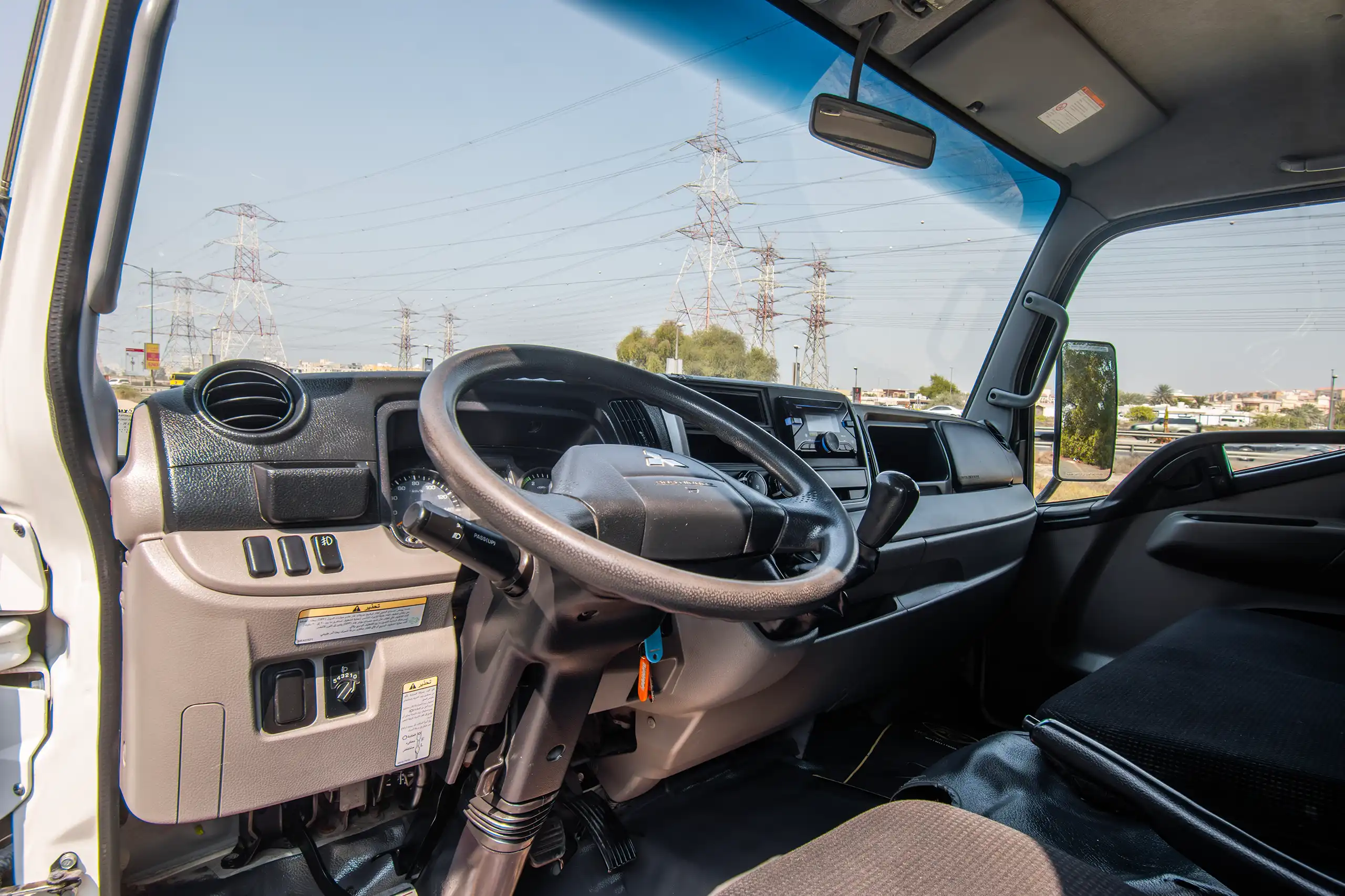 Used 2023 Mitsubishi Canter Double Cabin White – Driver Side Dashboard & Steering View at First Choice Cars Sharjah