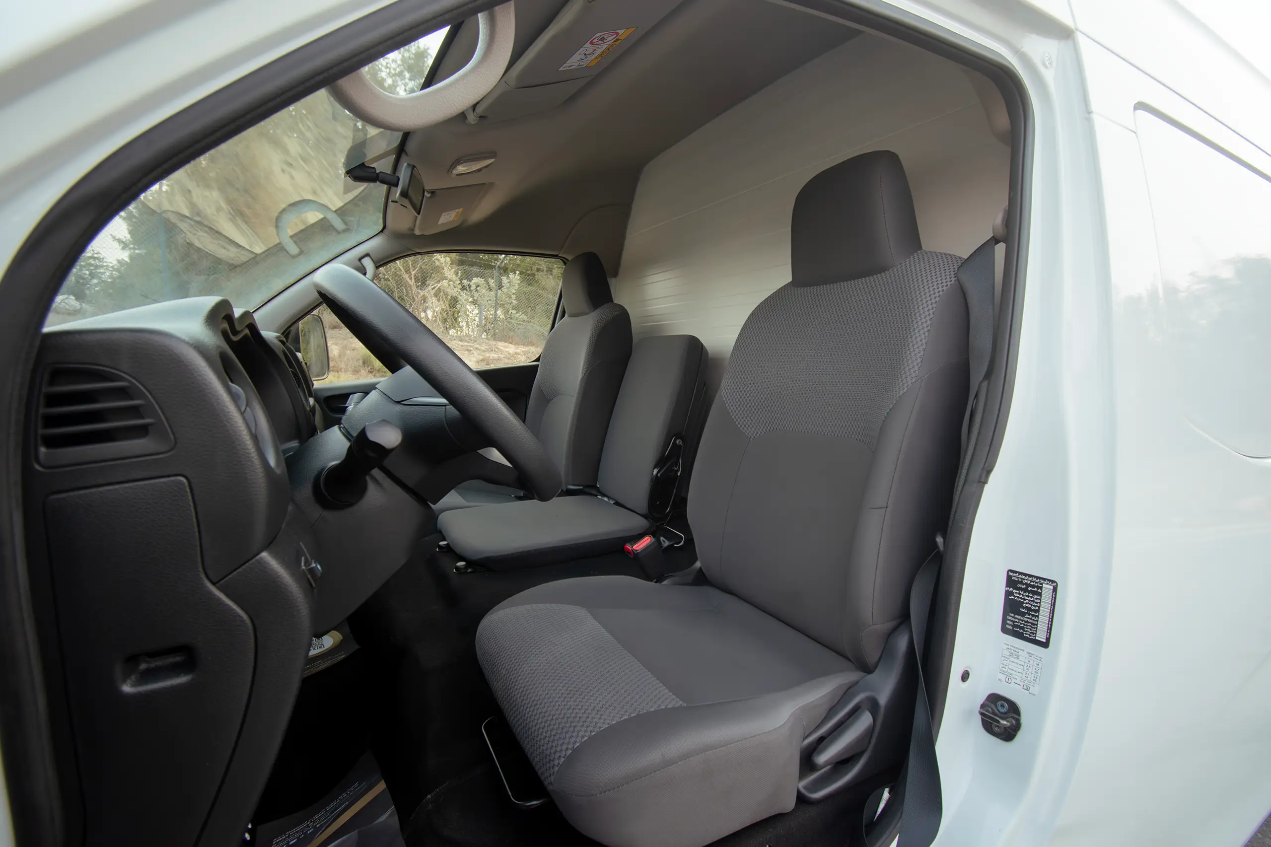 Used 2023 Nissan Urvan High Roof Chiller White – Front Driver Side Cabin View at First Choice Cars Sharjah