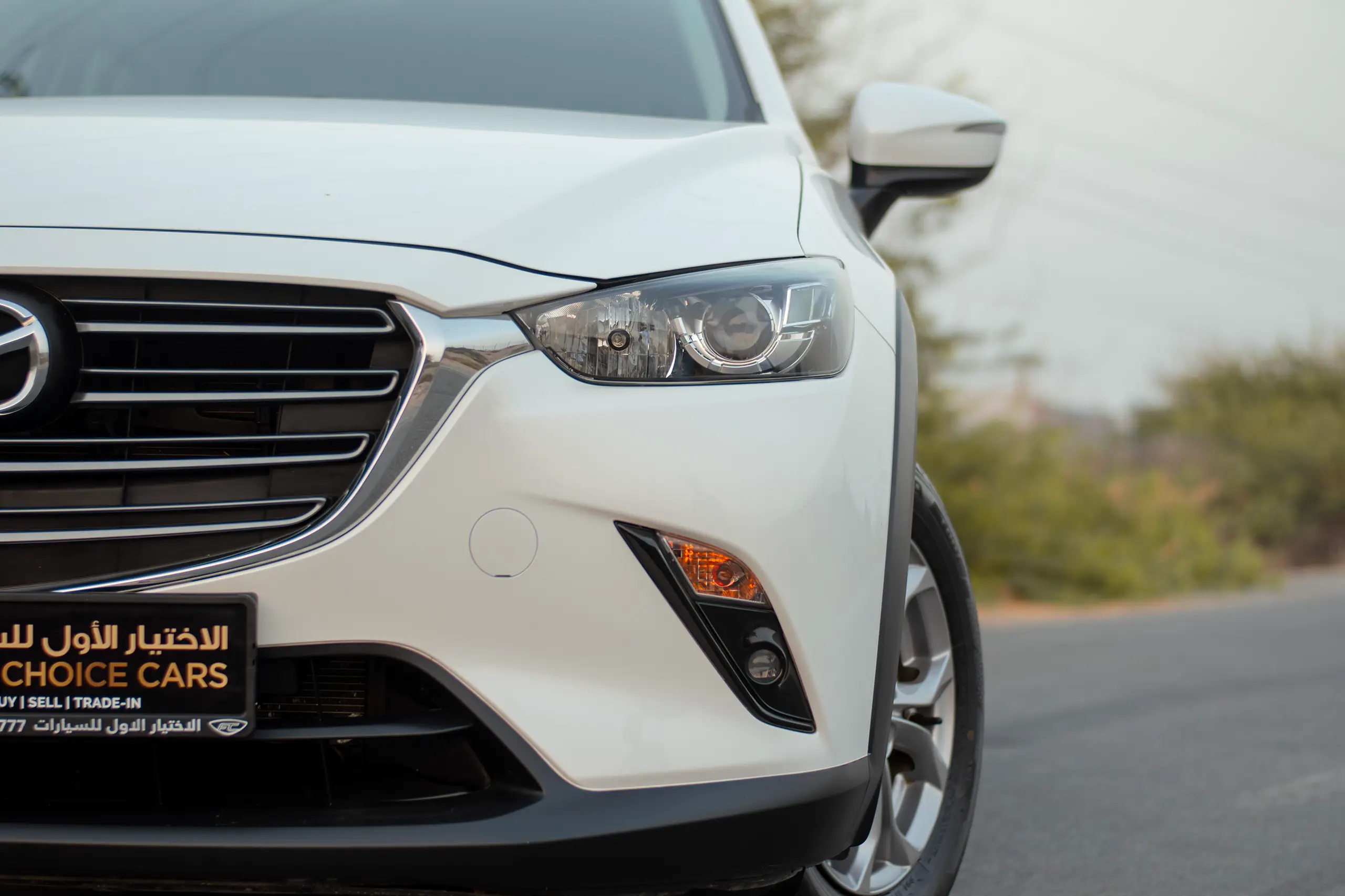 Used 2023 Mazda CX-3 Gs White – Headlight Close-up at First Choice Cars Sharjah