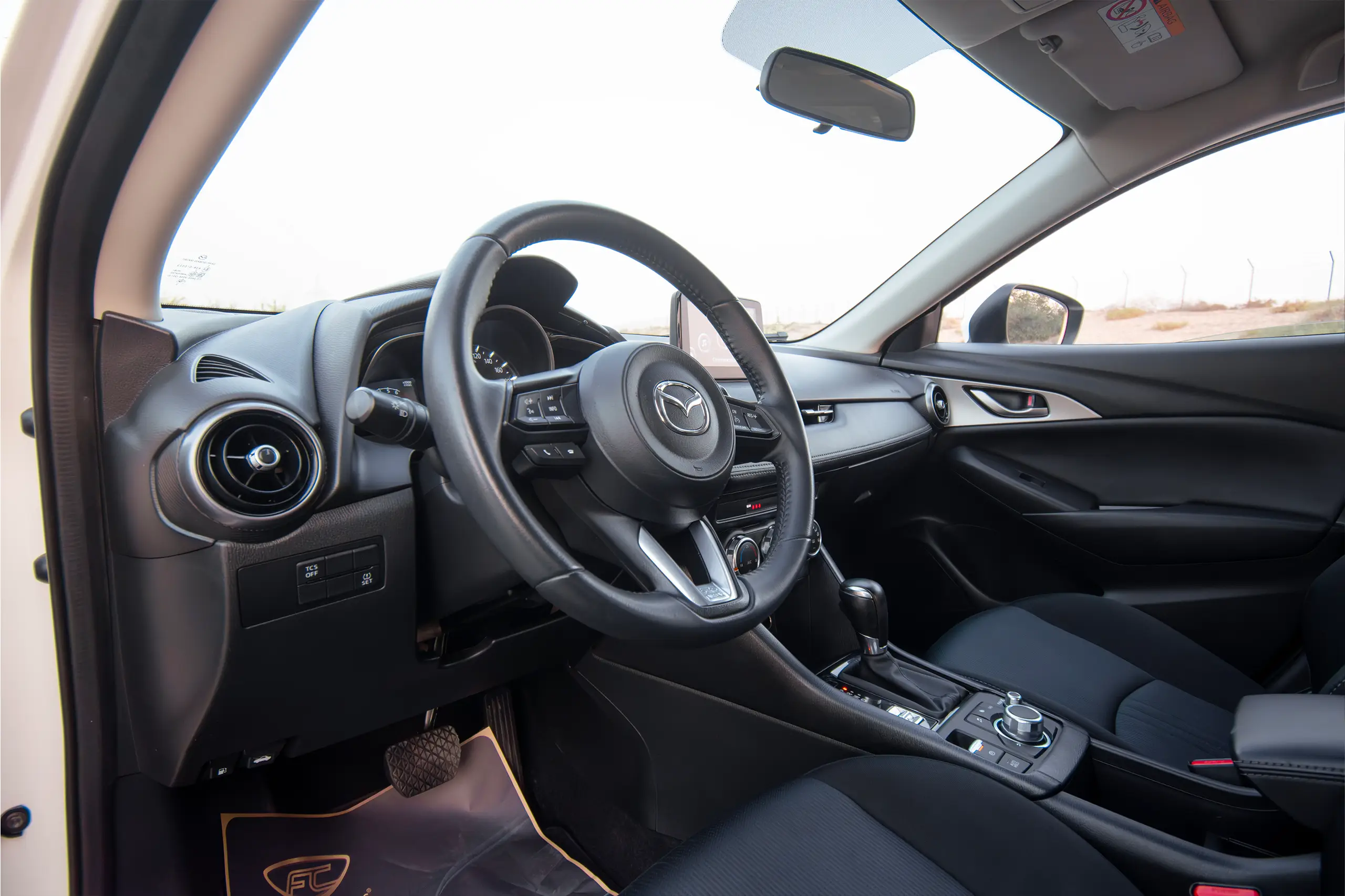 Used 2023 Mazda CX-3 Gs White – Driver Side Dashboard & Steering View at First Choice Cars Sharjah
