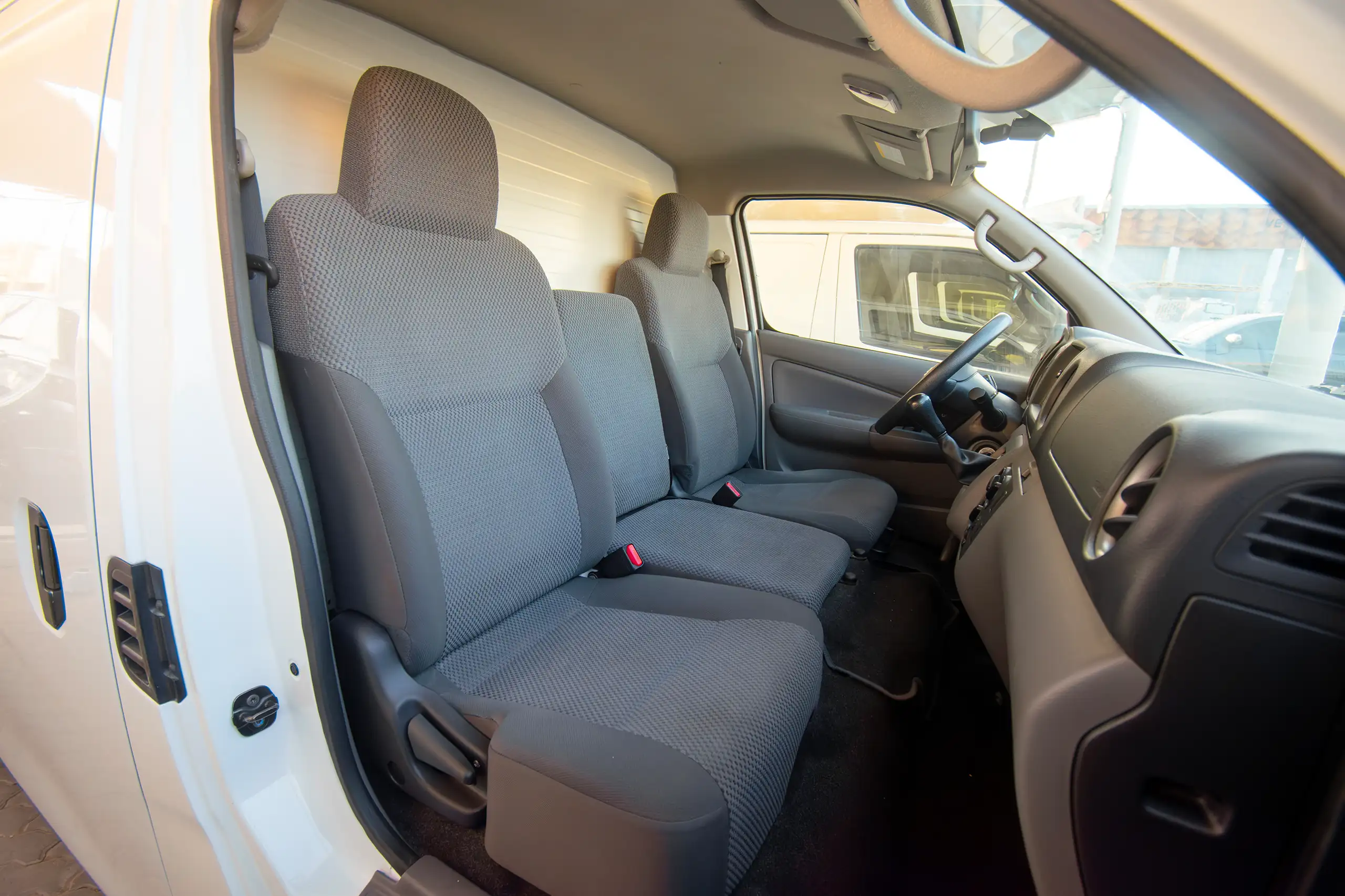 Used 2022 Nissan Urvan Standard Roof Chiller White – Front Passenger Side Cabin View at First Choice Cars Sharjah