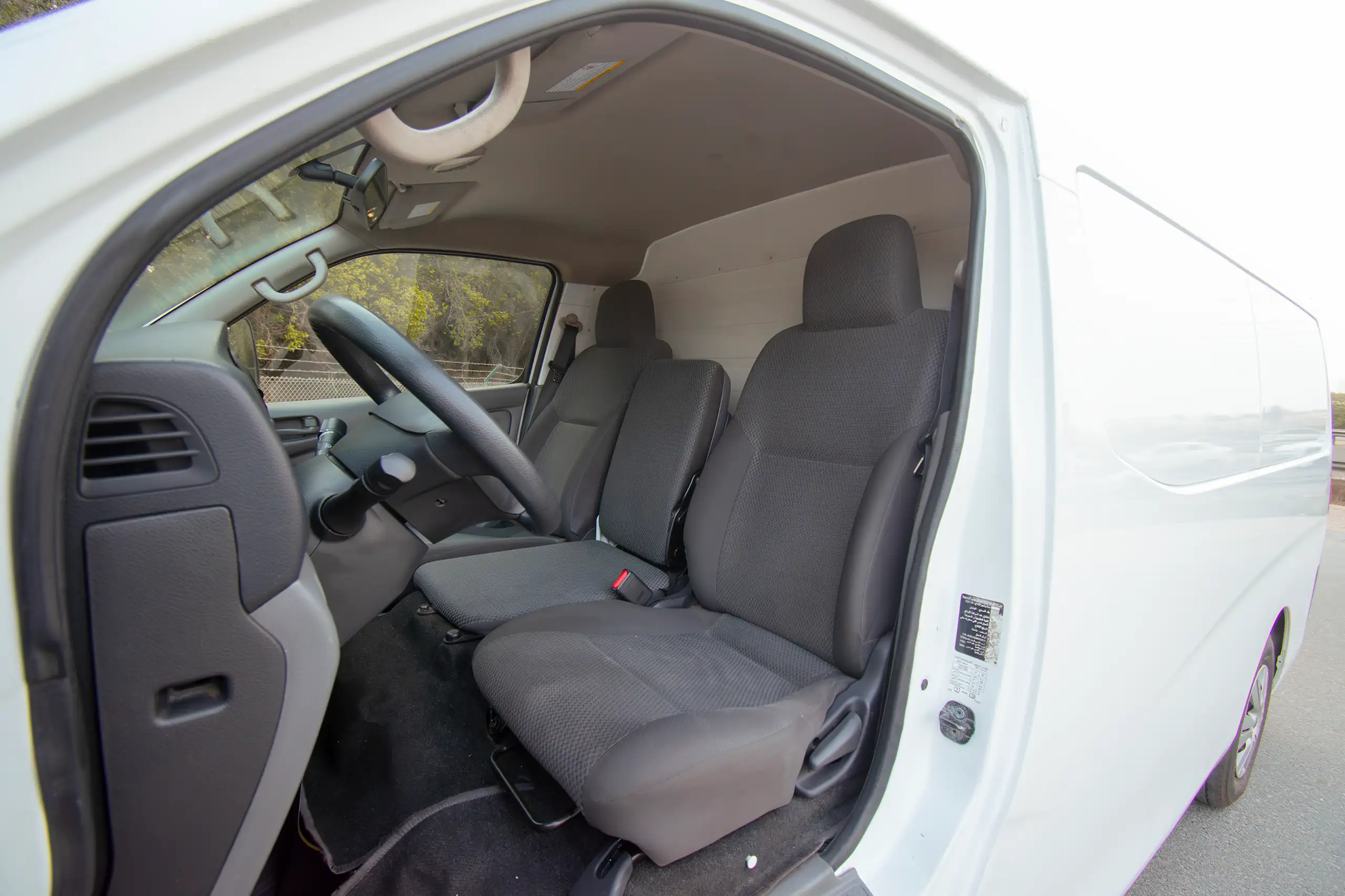 Used 2022 Nissan Urvan Standard Roof Chiller White – Front Driver Side Cabin View at First Choice Cars Sharjah