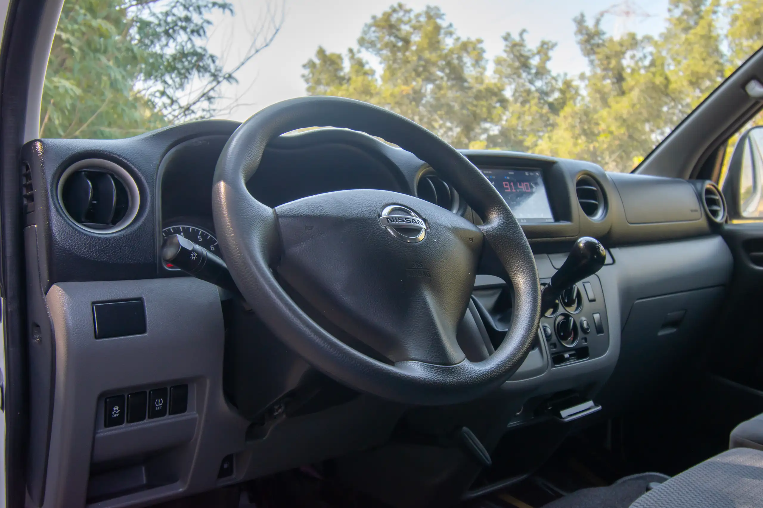 Used 2022 Nissan Urvan Standard Roof Chiller White – Driver Side Dashboard & Steering View at First Choice Cars Sharjah
