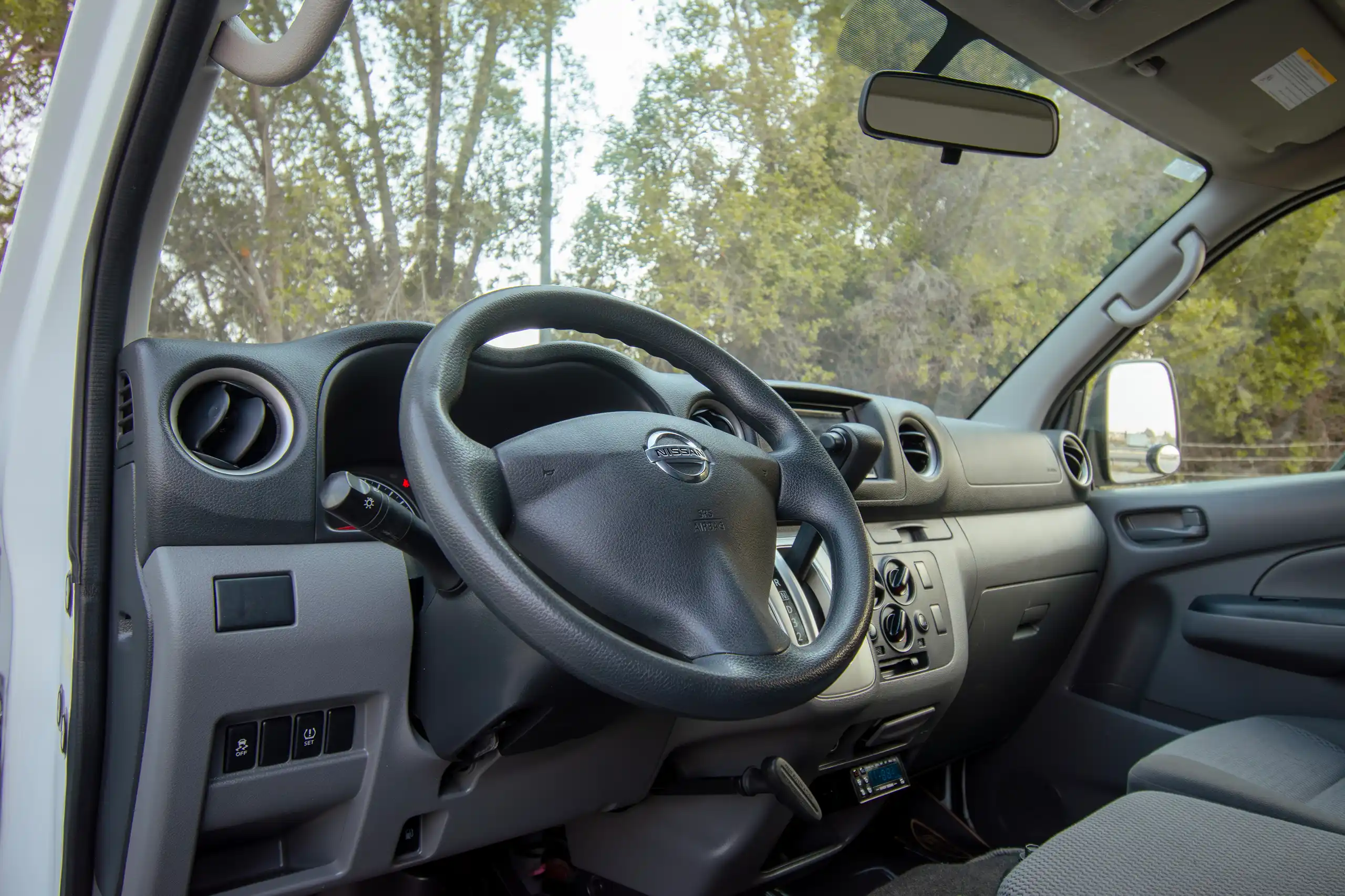 Used 2022 Nissan Urvan Standard Roof Chiller White – Driver Side Dashboard & Steering View at First Choice Cars Sharjah