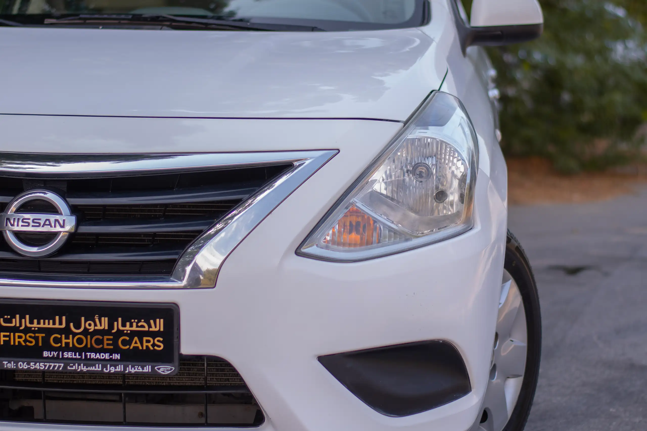 Used 2022 Nissan Sunny SV White – Headlight Close-up at First Choice Cars Sharjah
