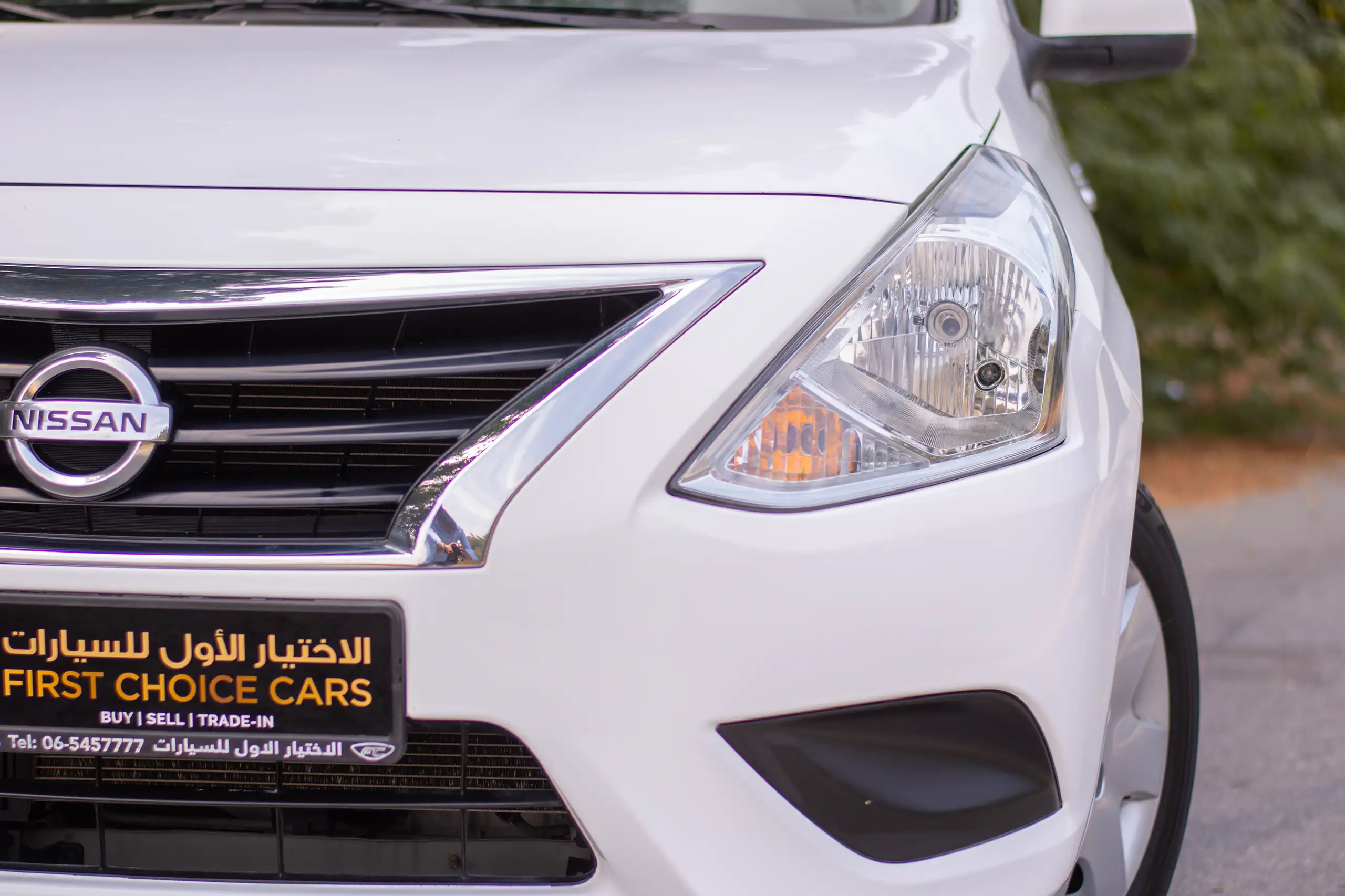 Used 2022 Nissan Sunny SV White – Headlight Close-up at First Choice Cars Sharjah