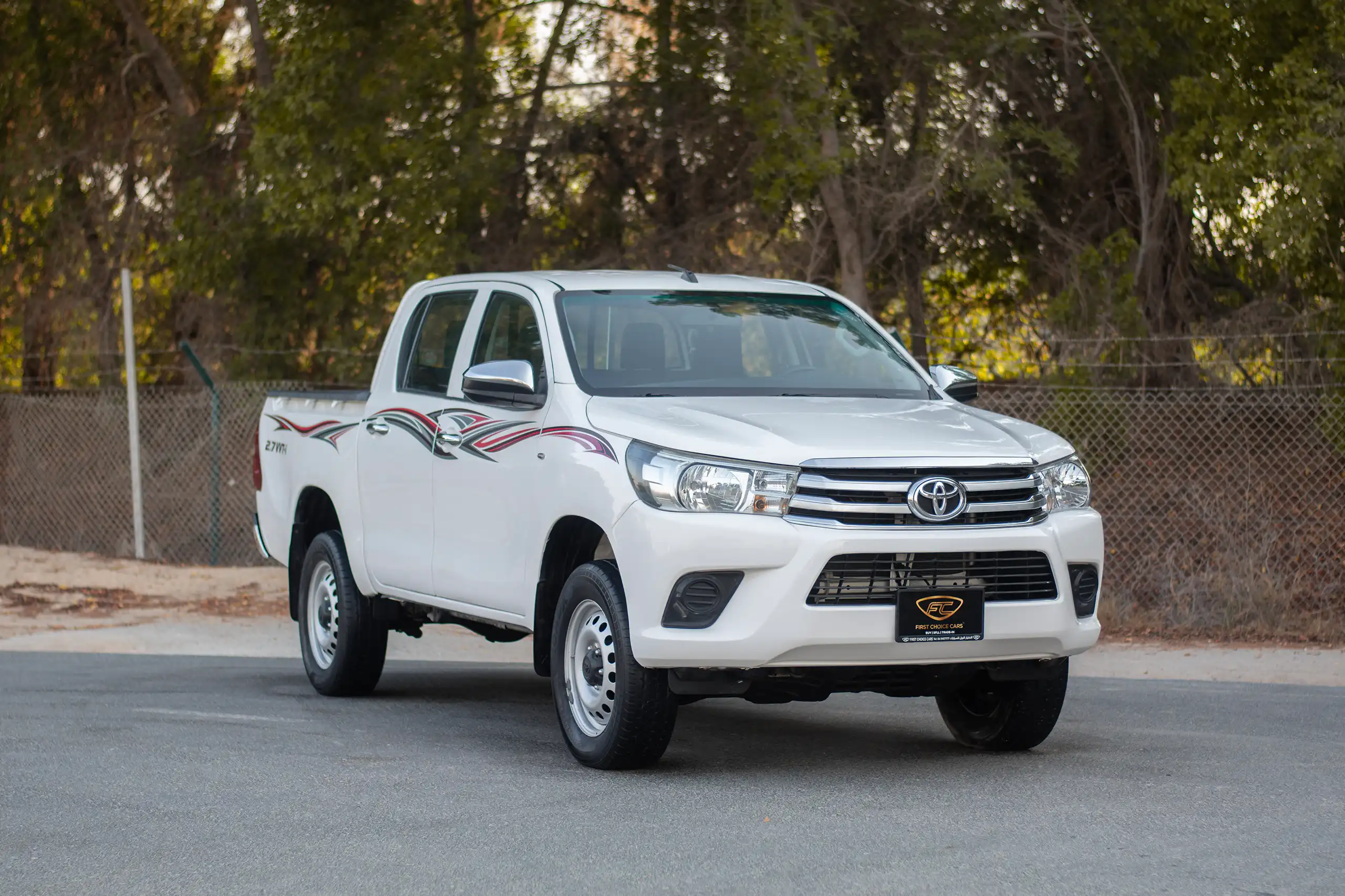Used 2021 Toyota Hilux GLX Double Cabin 2.7L 4x4 (petrol) White – Right Front Diagonal (45°) View at First Choice Cars Sharjah