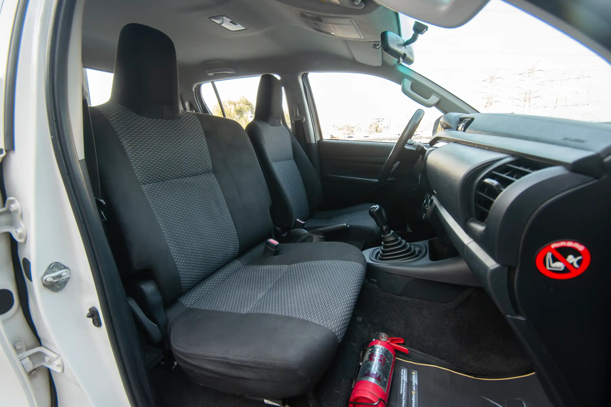 Used 2021 Toyota Hilux GLX Double Cabin White – Front Passenger Side Cabin View at First Choice Cars Sharjah