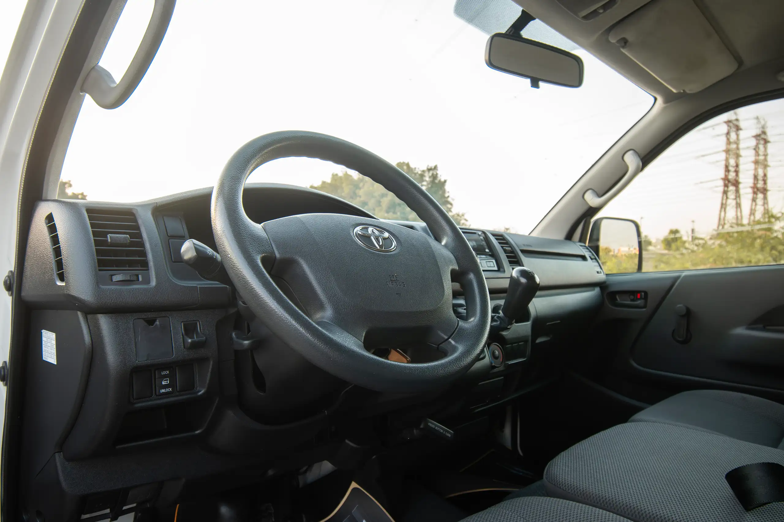 Used 2021 Toyota Hiace GL Std Roof 3 STR Panel Van White – Driver Side Dashboard & Steering View at First Choice Cars Sharjah