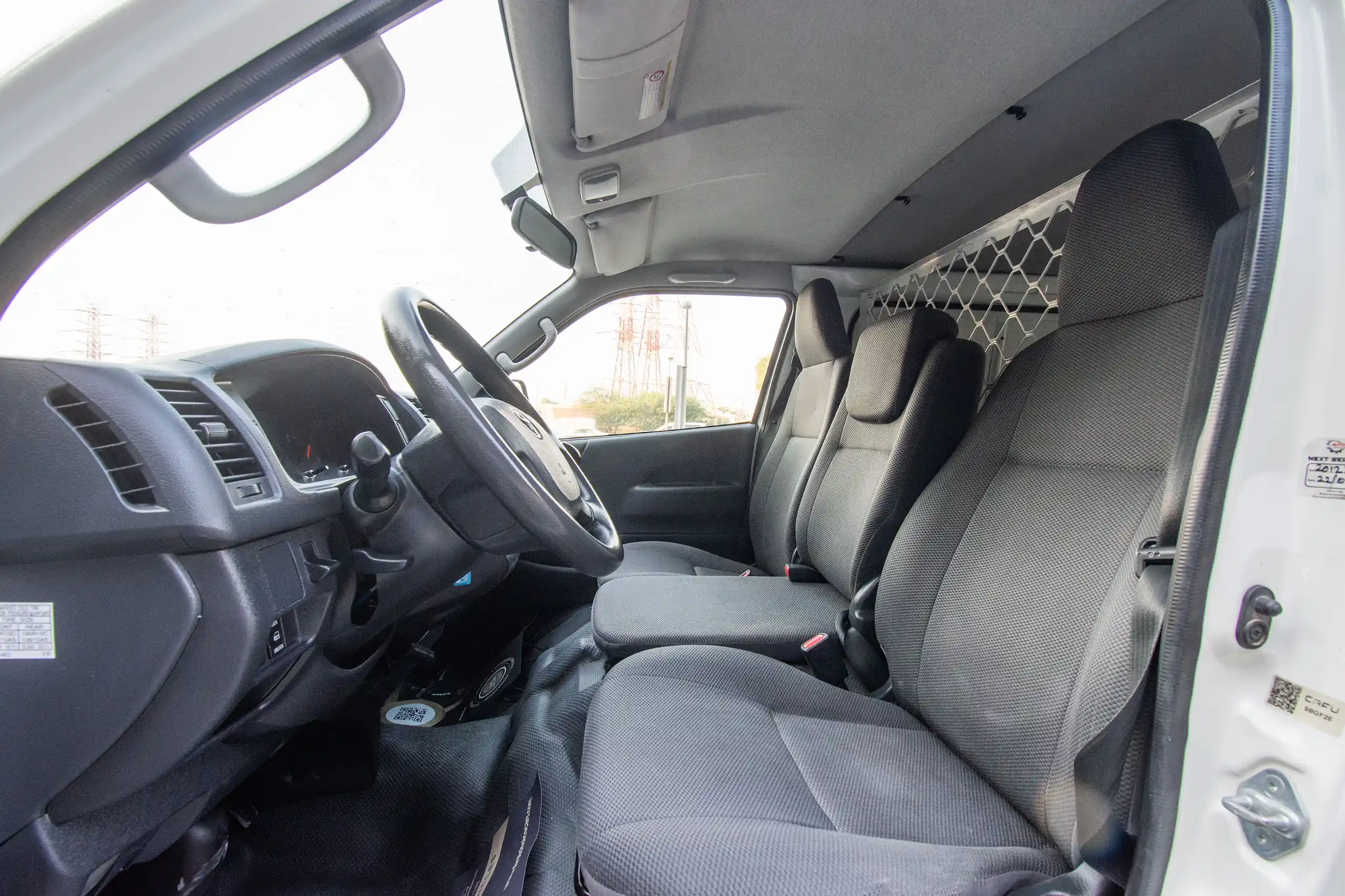 Used 2021 Toyota Hiace GL Std Roof 3 STR Panel Van White – Front Driver Side Cabin View at First Choice Cars Sharjah
