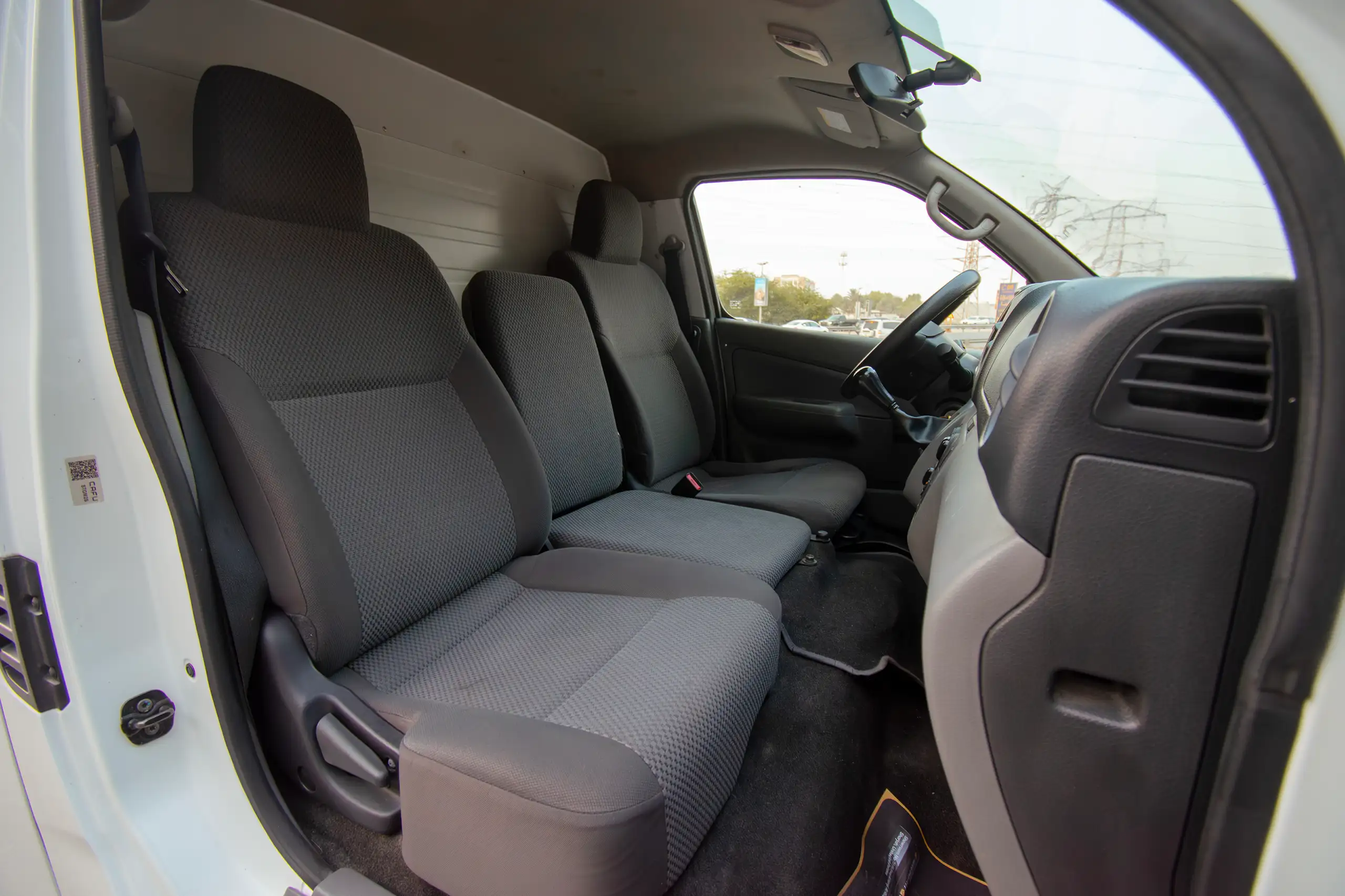 Used 2021 Nissan Urvan Standard Roof Chiller White – Front Passenger Side Cabin View at First Choice Cars Sharjah