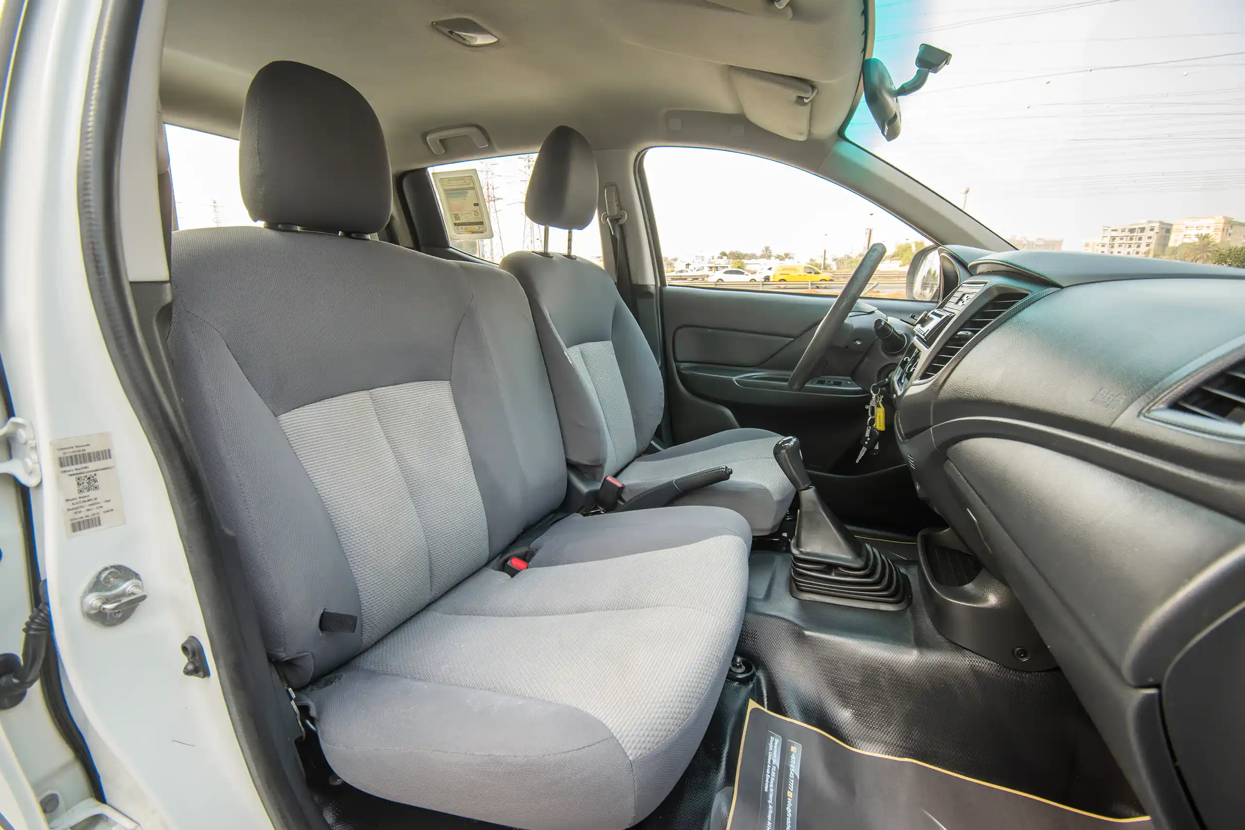 Used 2021 Mitsubishi L200 Double Cab GLX White – Front Passenger Side Cabin View at First Choice Cars Sharjah