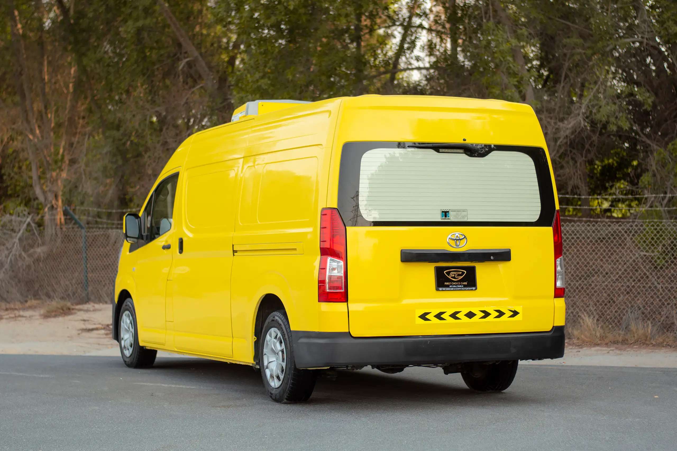 Used 2020 Toyota Hiace GL- High Roof Yellow – Left Back Diagonal (45°) View at First Choice Cars Sharjah