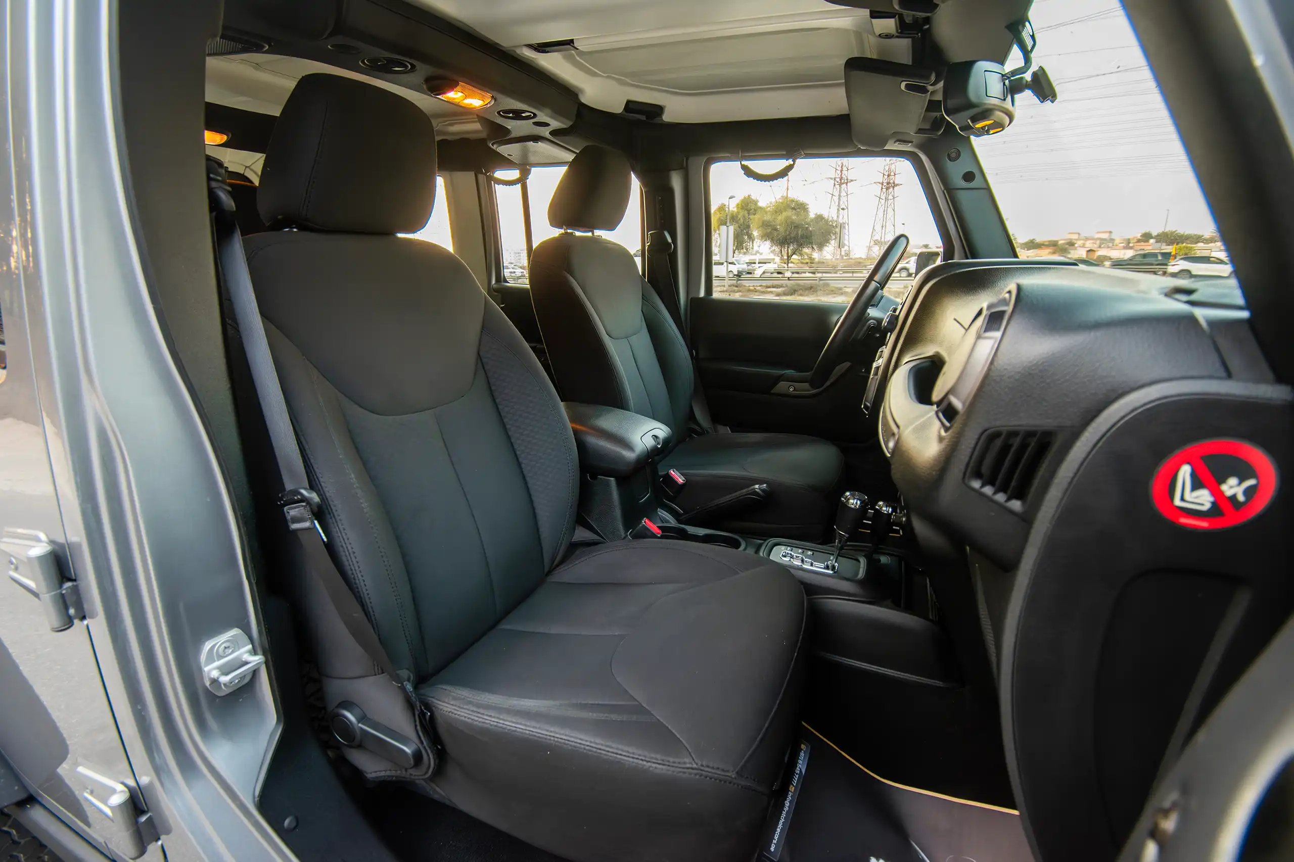 Used 2018 Jeep Wrangler Unlimited Willys Wheeler Silver – Front Passenger Side Cabin View at First Choice Cars Sharjah