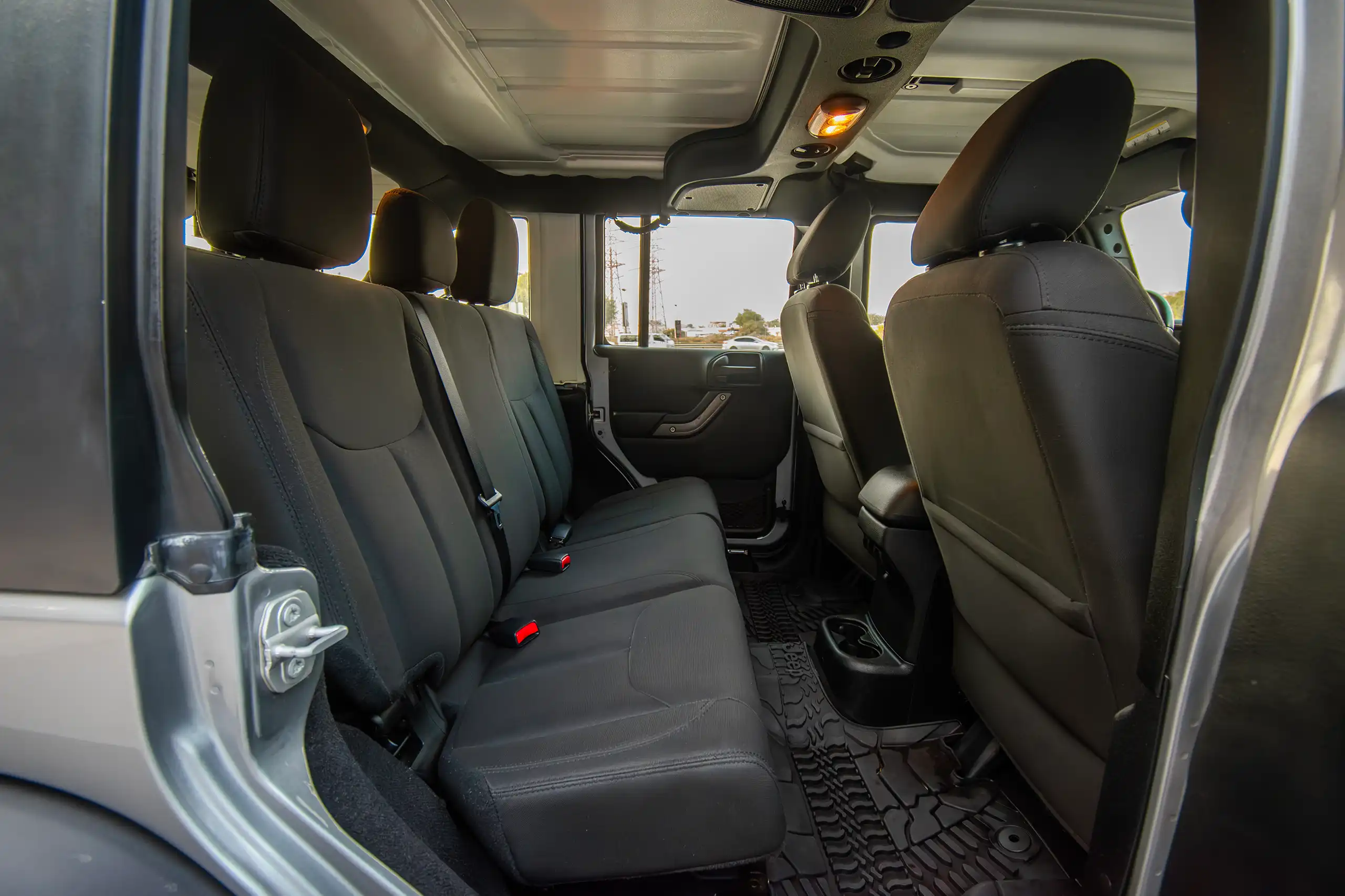 Used 2018 Jeep Wrangler Unlimited Willys Wheeler Silver – Rear Passenger Side Cabin View at First Choice Cars Sharjah