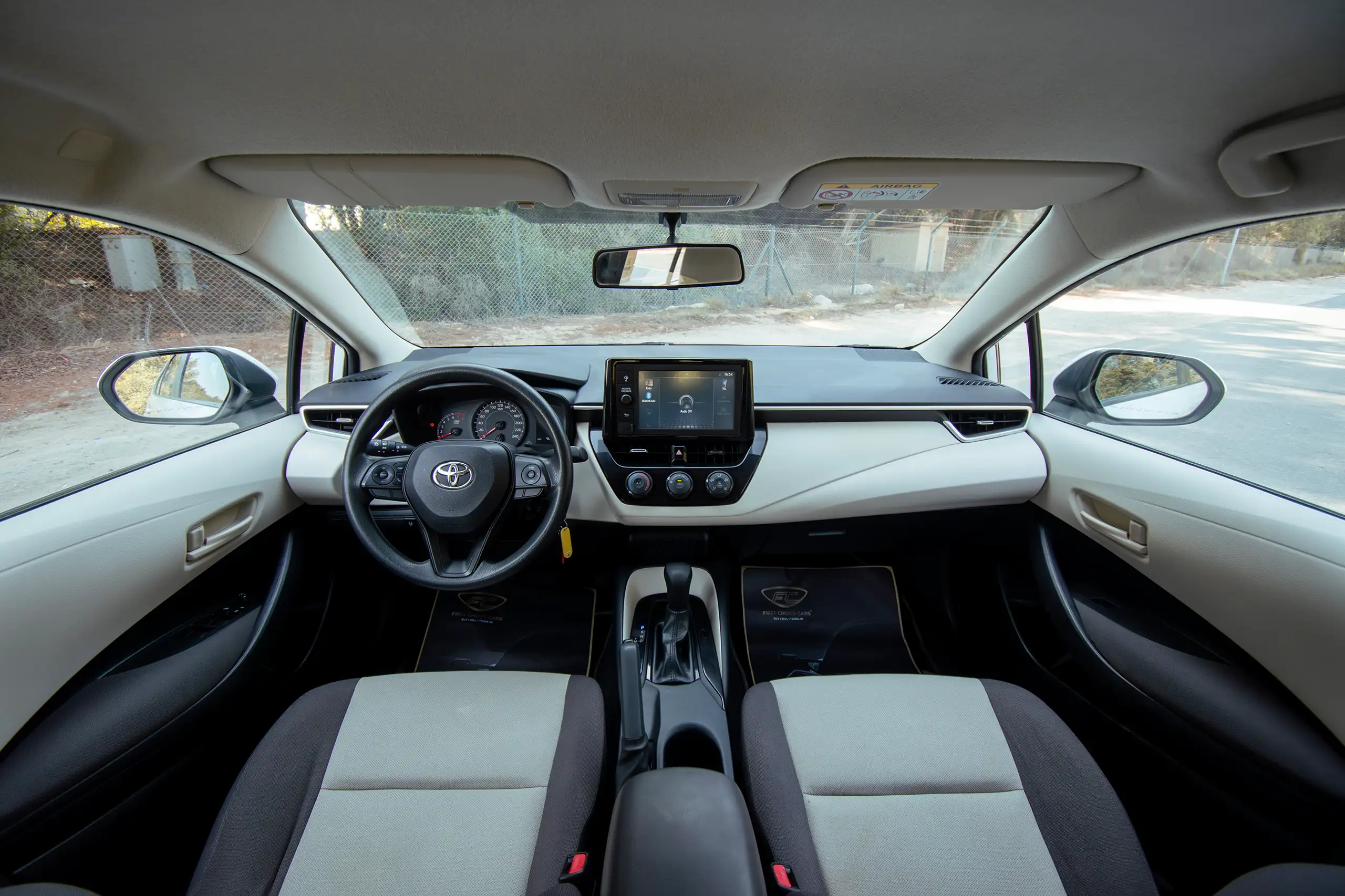 Used 2022 Toyota Corolla Xli White – Front Cabin / Dashboard Full View at First Choice Cars Sharjah