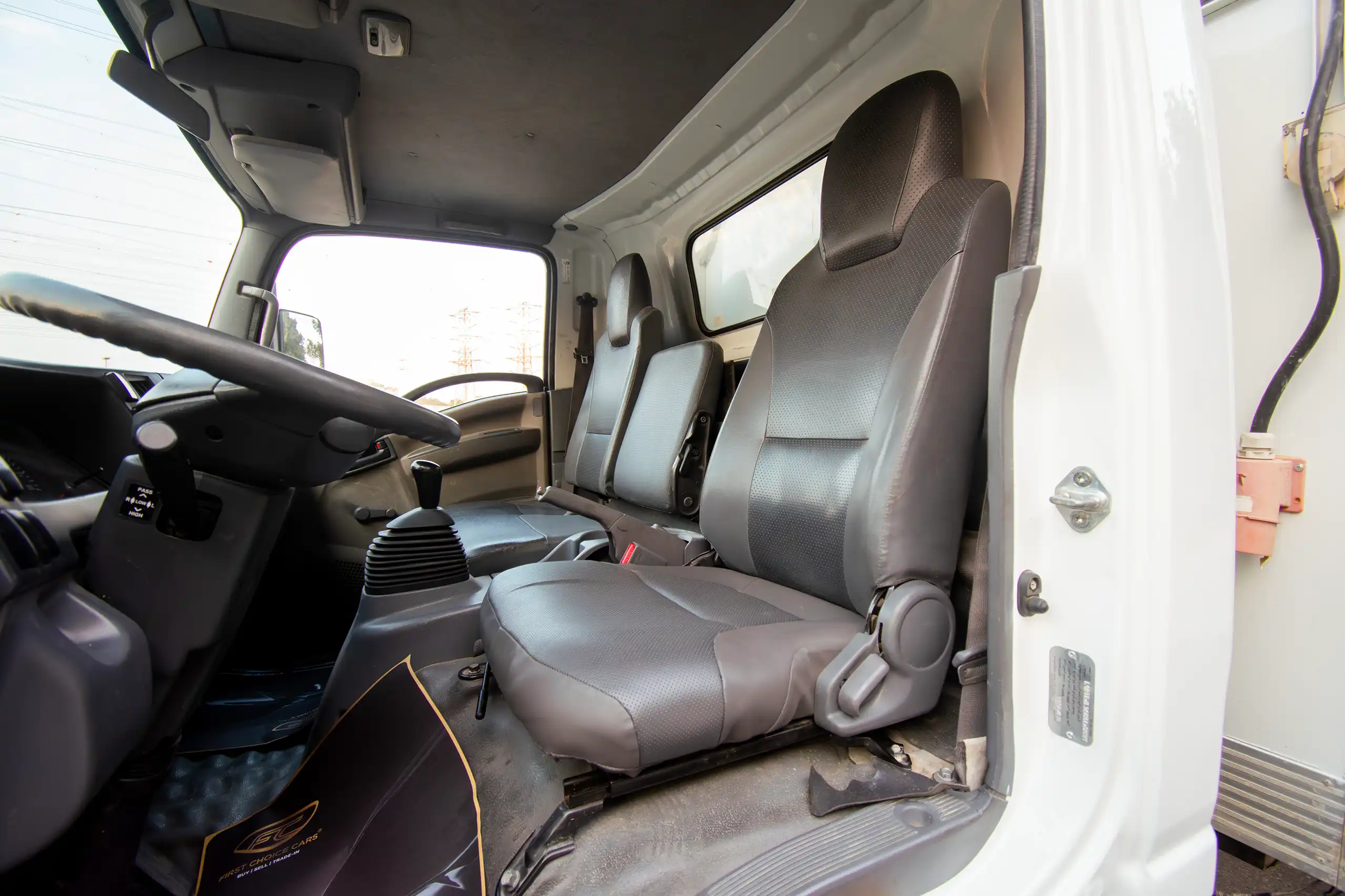 Used 2016 Isuzu N-Series Npr White – Front Driver Side Cabin View at First Choice Cars Sharjah