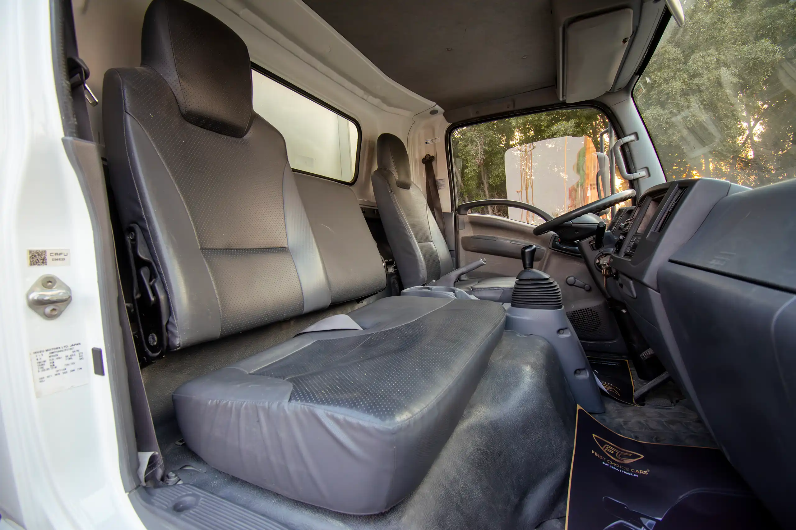 Used 2016 Isuzu N-Series Npr White – Front Passenger Side Cabin View at First Choice Cars Sharjah