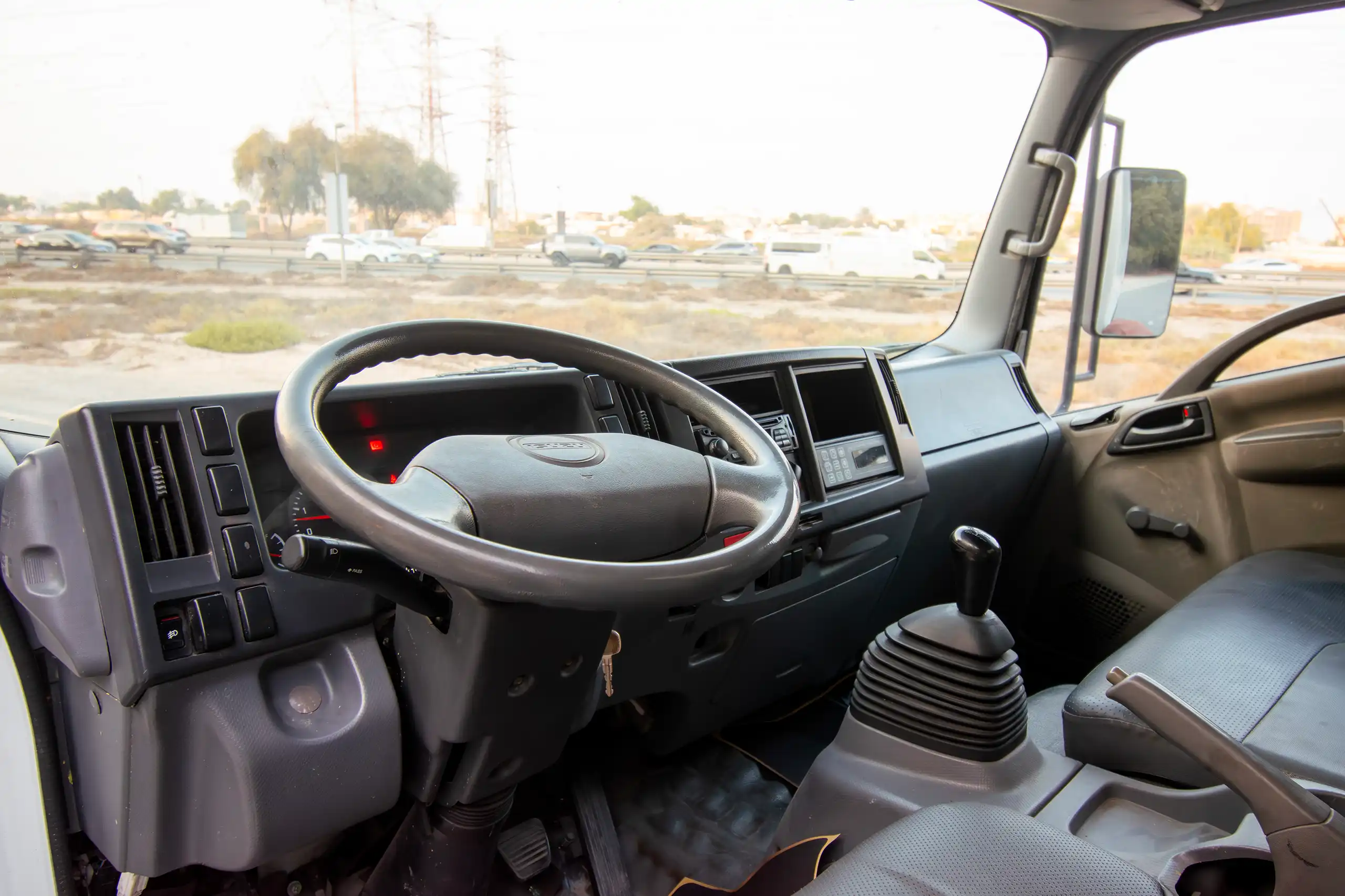 Used 2016 Isuzu N-Series Npr White – Driver Side Dashboard & Steering View at First Choice Cars Sharjah
