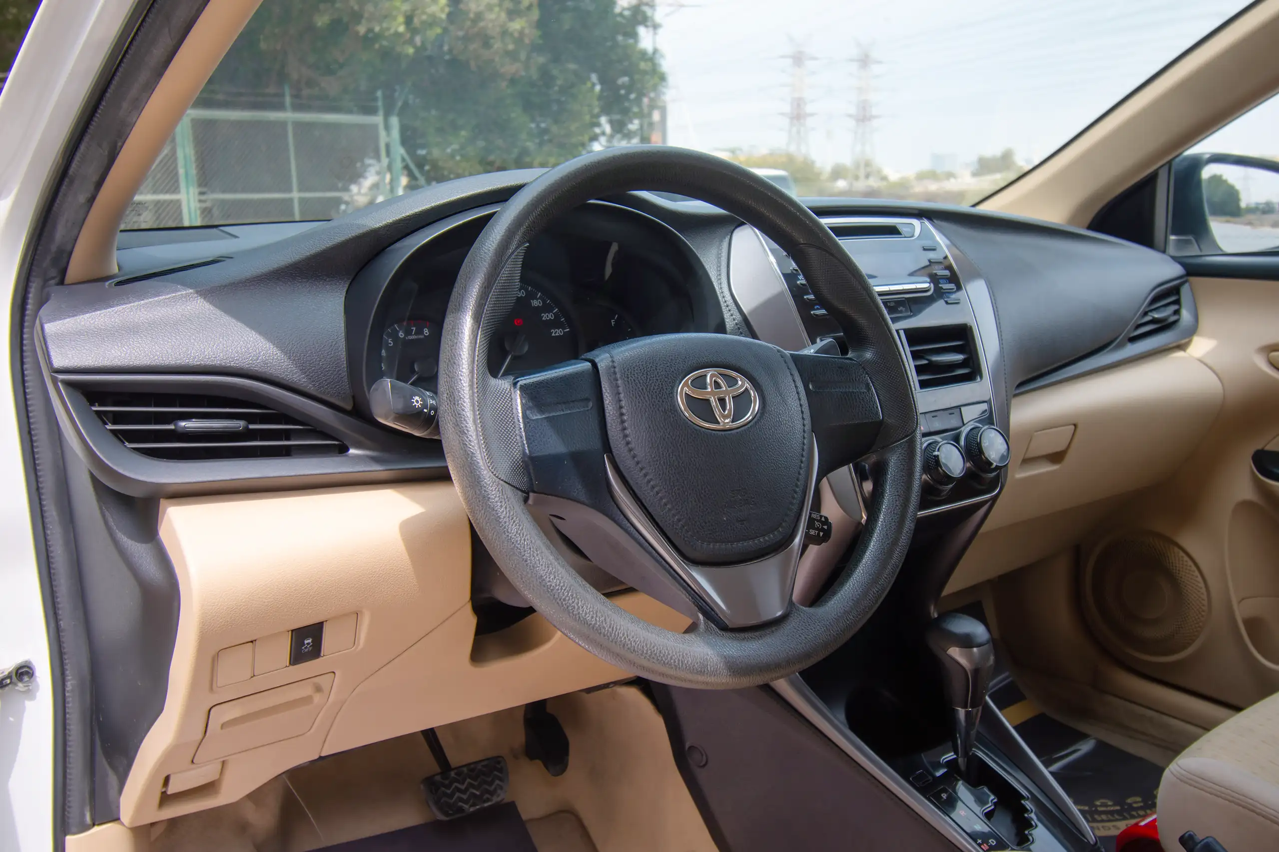 Used 2022 Toyota Yaris E White – Driver Side Dashboard & Steering View at First Choice Cars Sharjah
